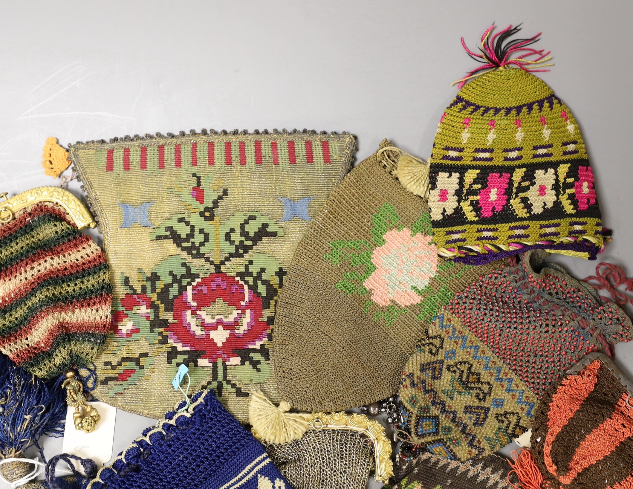 Sixteen mixed 19th century knitted and crochet purses, misers purses, reticules and a woven gilt metal bible bag